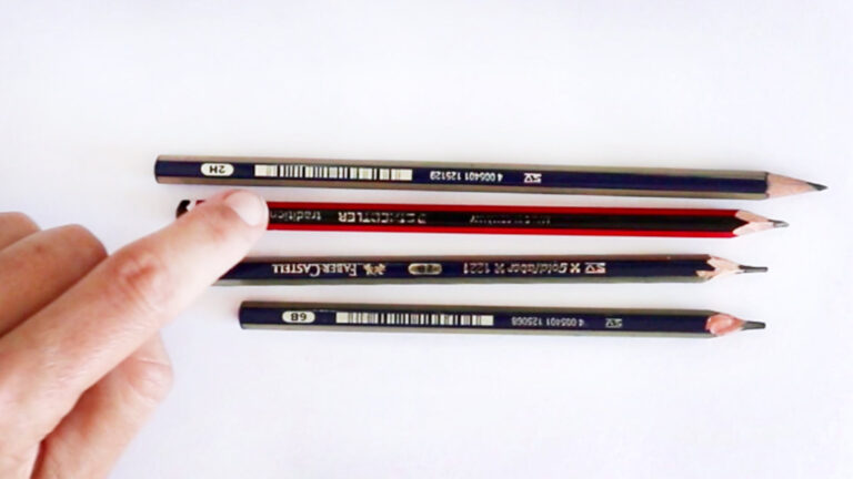 photo showing a finger pointing at four different grades of pencils